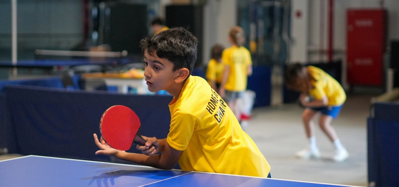 A boy about to serve the ball at ISD table tennis academy in dubai sports city