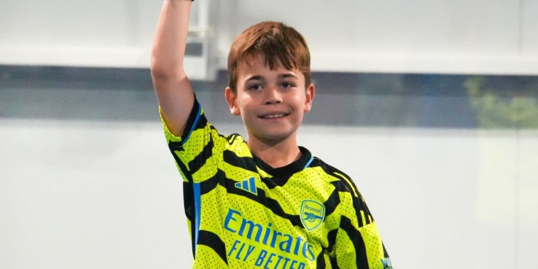 A happy kid celebrating a point at ISD Padel Academy in Dubai Sports City