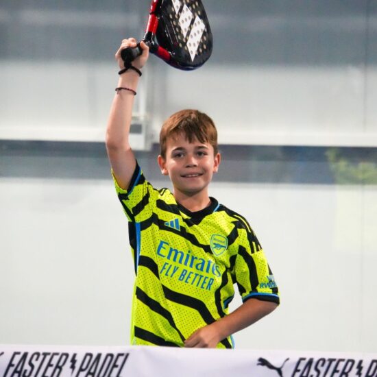 A happy kid celebrating a point at ISD Padel Academy in Dubai Sports City