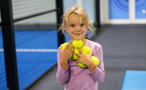 A young girl doing a Padel drill at ISD Padel Academy in Dubai Sports City