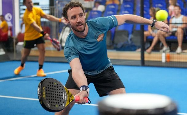 A young man playing padel in one of ISD Padel's indoor padel courts in dubai sports city (2)