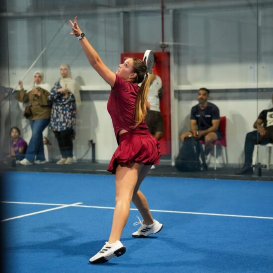 Padel coach Angelina N (Coach Angy) playing padel in one of ISD Padel's padel courts in dubai