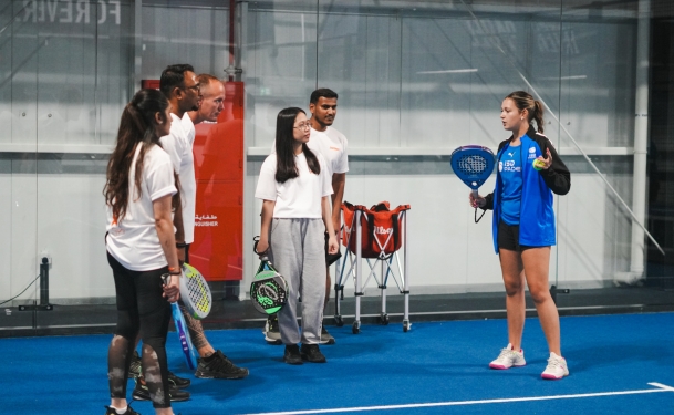 Padel coach Angelina N, also known as Padel coach Angy, having an animated conversation during her padel lessons in Dubai Sports City