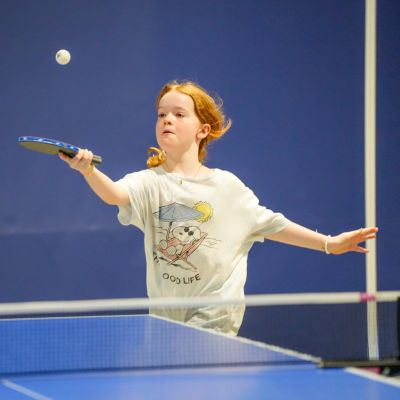 A young girl playing table tennis at ISD Table Tennis Academy in Dubai Sports City