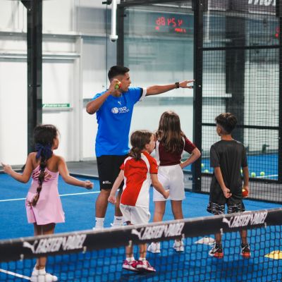 Padel coach Dani Casanova teaching kids at ISD Padel Academy in Dubai Sports City