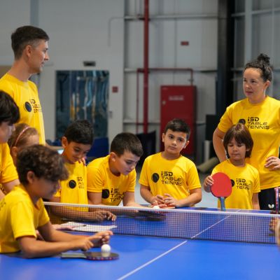 Table Tennis Coach Alexey Livenstov and Table Tennis Coach Yulia Prokhorova with their young students at ISD Table Tennis Academy in Dubai Sports City