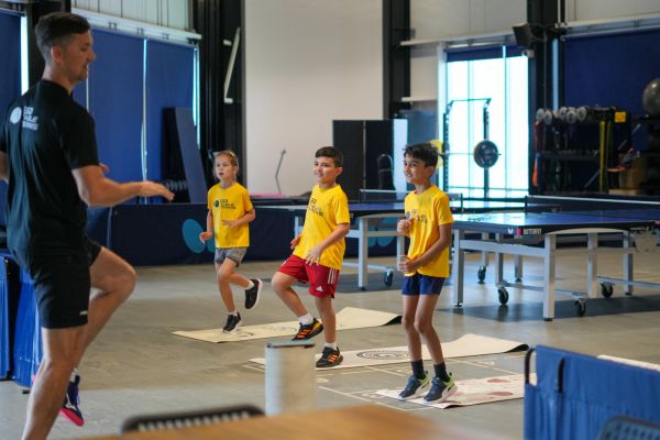 3 young kids doing a table tennis drill at ISD Table Tennis in Dubai Sports City