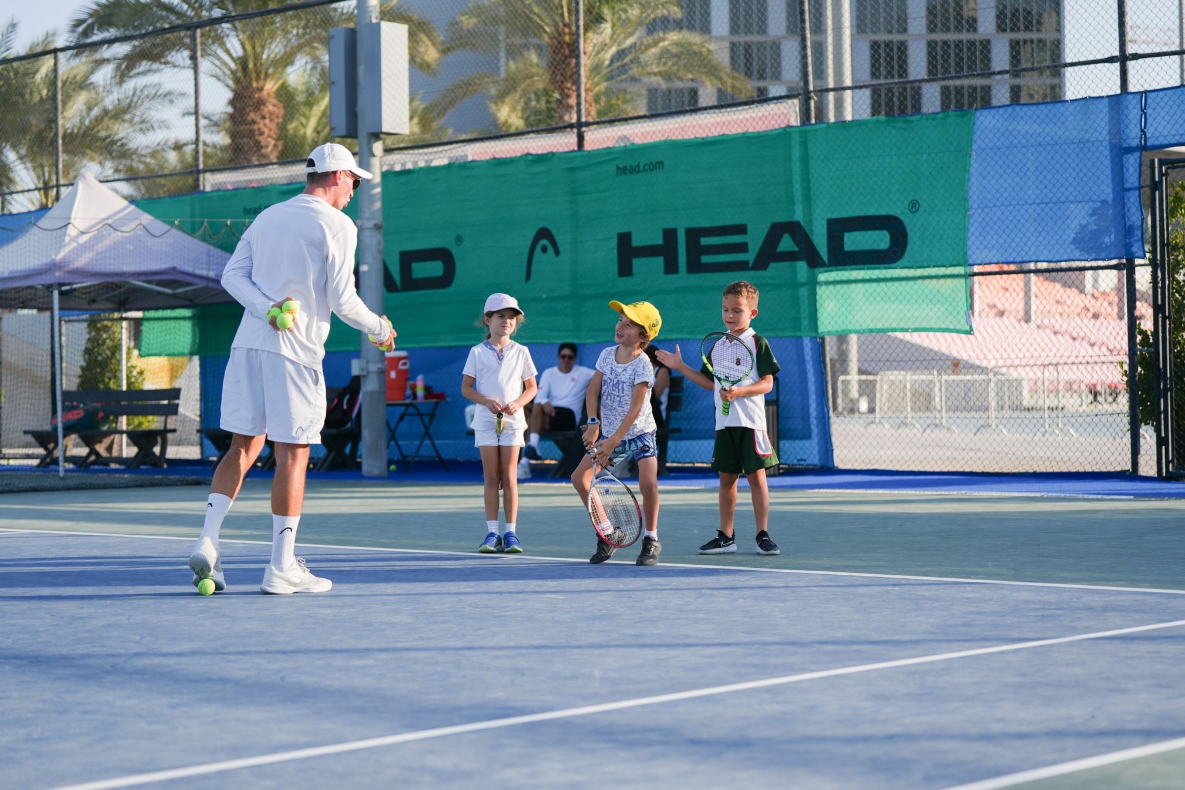 A Tennis coach during a session with kids at ISD ProStyle Tennis Academy in Dubai Sports City