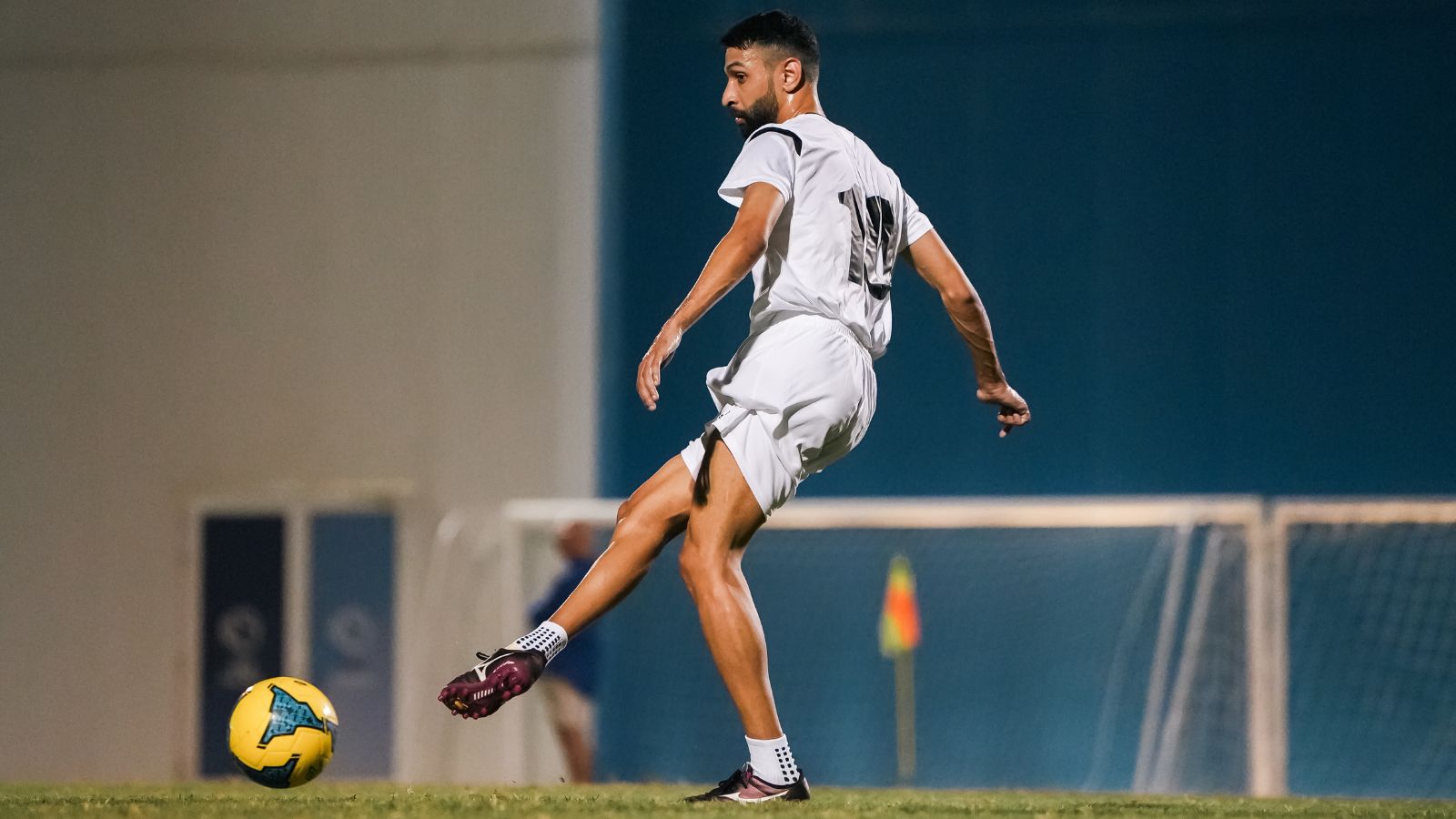 A corporate football player kicking a football during a match in the Dubai corporate football league (2)