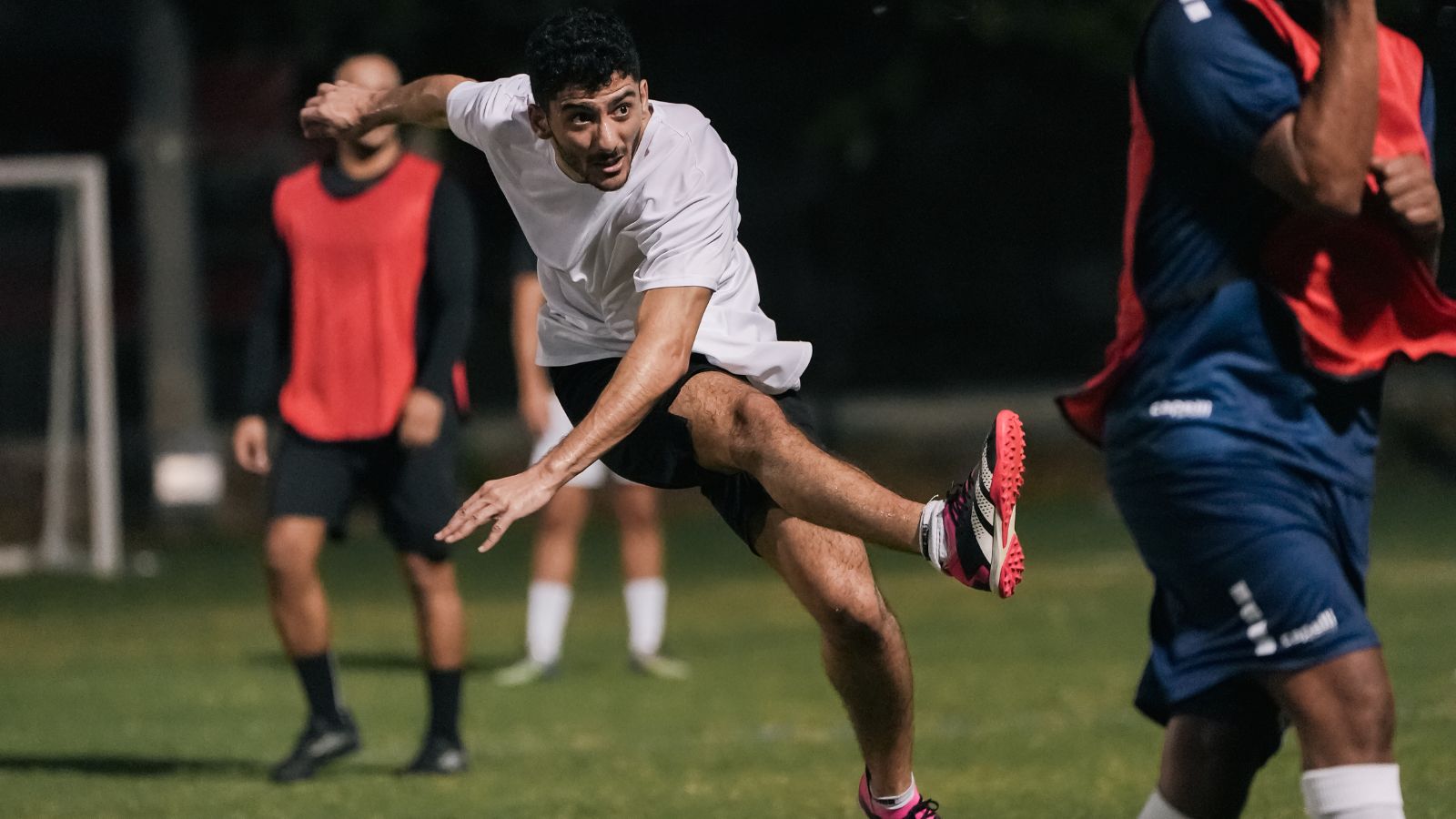 A corporate football player kicking a football during a match in the Dubai corporate football league (3)