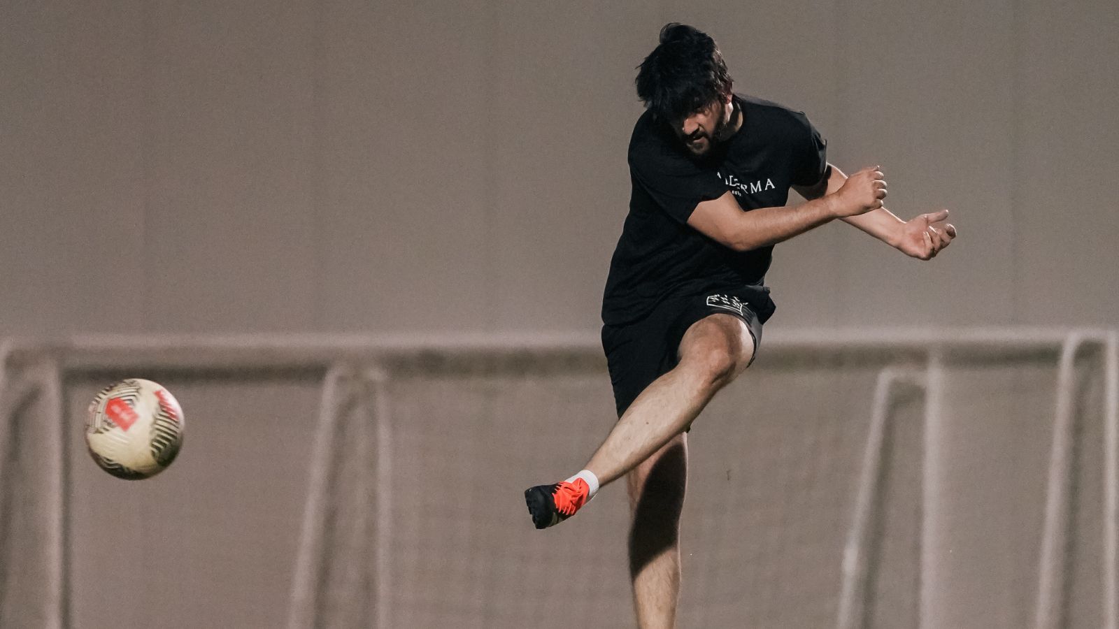 A corporate football player kicking a football during a match in the Dubai corporate football league (4)