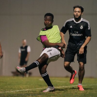 A corporate football player kicking the football during a match in the Dubai Corporate Football League held at ISD Dubai Sports City in Dubai Sports City