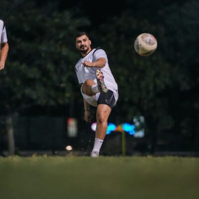 A corporate football player practicing before his football match in the Dubai Corporate Football League organized by ISD Football at ISD Dubai Sports City