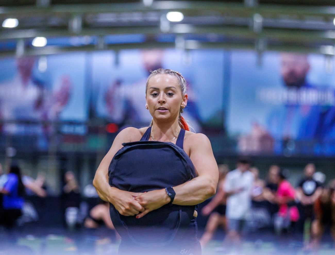 A lady carrying a sand bag during an event in the precision pairs competition held at ISD Dubai Sports City