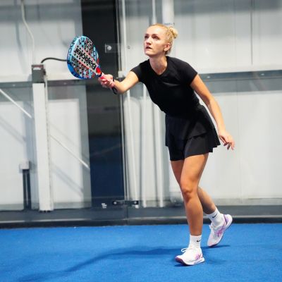 A lady in the middle of a Padel match at ISD Padel in Dubai Sports City (3)