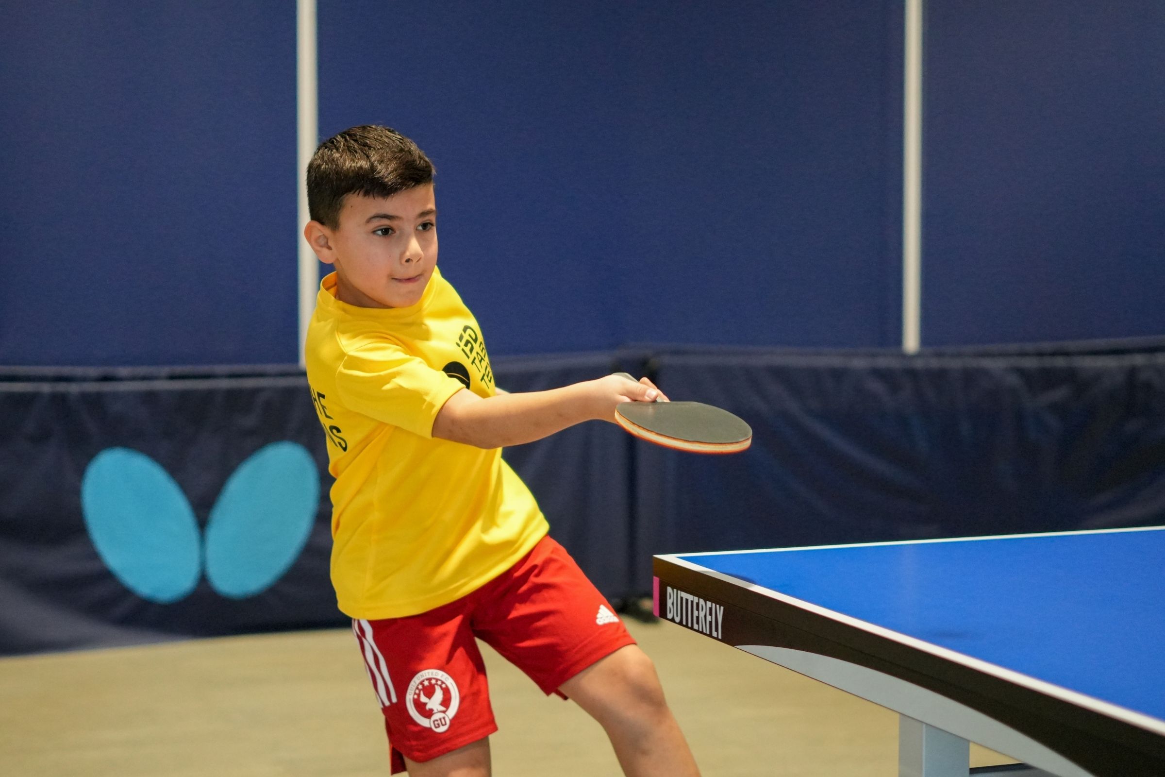 A young boy practicing Table Tennis at ISD Table Tennis in Dubai Sports City