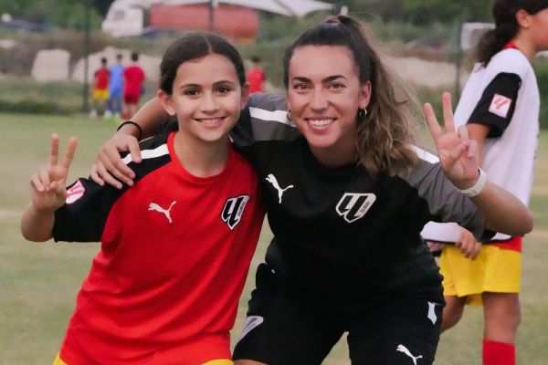 A young girl with Girl's Head Coach Dafne Martinez at LaLiga Academy Dubai in Dubai Sports City