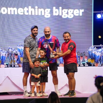 Corporate athletes onstage with their families accepting their prizes during the Dubai Corporate Games 2025 in ISD Dubai Sports City
